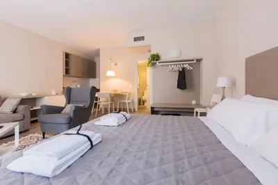a bedroom with a large bed and a living room at Flateli 430 BCN in Barcelona