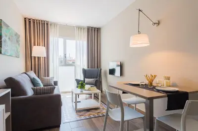 a living room and dining room with a table and a couch at Flateli 430 BCN in Barcelona