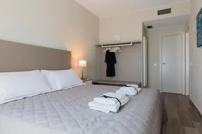 a bedroom with a bed with three towels on it at Flateli 430 BCN in Barcelona