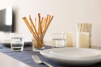 a table with a plate and two glasses of water at Flateli 430 BCN in Barcelona
