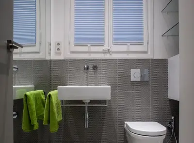 a bathroom with a sink and a toilet and windows at Villaroel · Modern flat in San Antoni in Barcelona