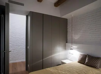 a bedroom with a bed and a wall at Villaroel · Modern flat in San Antoni in Barcelona