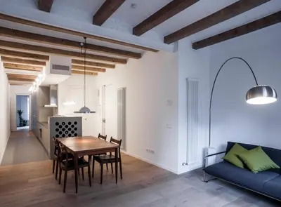 a dining room and living room with a table and chairs at Villaroel · Modern flat in San Antoni in Barcelona