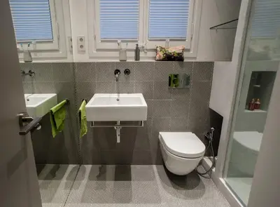 a bathroom with a white sink and a toilet at Villaroel · Modern flat in San Antoni in Barcelona