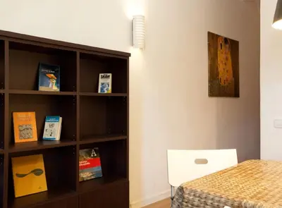 a bedroom with a book shelf next to a bed at Authentic flat2 in Poble sec - Paralelo in Barcelona