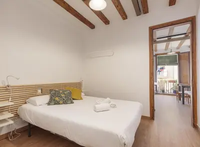 a bedroom with a white bed and a large window at Ndlr 2-4 · Authentic flat in Poble Sec - Paralelo in Barcelona