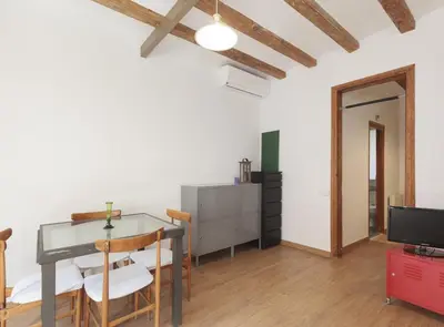 a dining room with a glass table and a television at Ndlr 2-4 · Authentic flat in Poble Sec - Paralelo in Barcelona