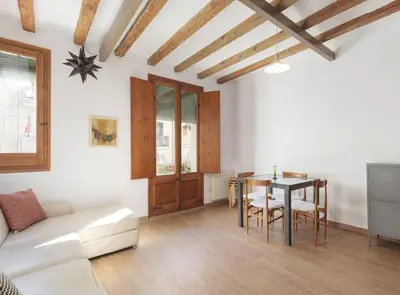 a living room with a table and a couch at Ndlr 2-4 · Authentic flat in Poble Sec - Paralelo in Barcelona