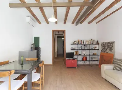a living room with a table and a couch at Ndlr 2-4 · Authentic flat in Poble Sec - Paralelo in Barcelona