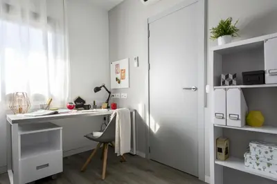 a white office with a desk and a chair at Residencia Universitaria Resa Barcelona Diagonal in Barcelona