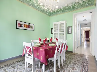 a dining room with a table and white chairs at Apartment in Barcelona near Passeig de Gràcia in Barcelona