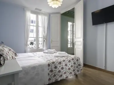 a white bedroom with a bed with towels on it at Apartment in Barcelona near Passeig de Gràcia in Barcelona
