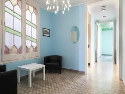 a waiting room with a chair and a table at Apartment in Barcelona near Passeig de Gràcia in Barcelona