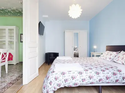 a bedroom with a large bed and a chandelier at Apartment in Barcelona near Passeig de Gràcia in Barcelona