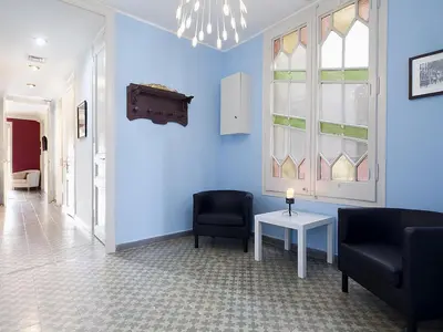 a room with blue walls and two chairs and a table at Apartment in Barcelona near Passeig de Gràcia in Barcelona