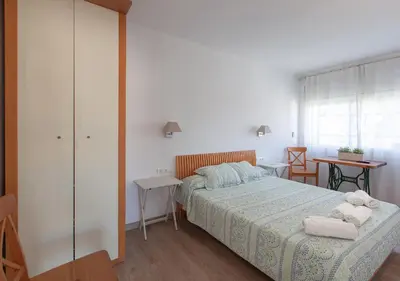 a bedroom with a bed with towels on it at Hola! - El Cortijo in Sitges