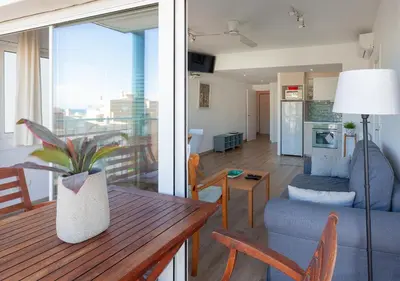 a living room with a table and a living room at Hola! - El Cortijo in Sitges