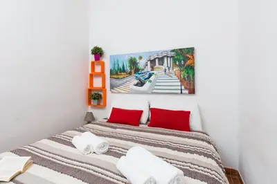 a bedroom with a bed with red pillows at Key Sagrada Familia - Carrer Del Clot in Barcelona