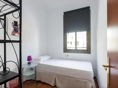 a bedroom with a bed and a window at Key Sagrada Familia - Carrer Del Clot in Barcelona