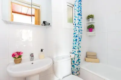 a white bathroom with a sink and a toilet at Key Sagrada Familia - Carrer Del Clot in Barcelona