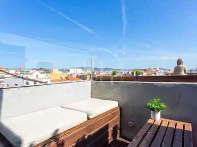 a balcony with a bench and a view of a city at Attic Terrace Montjuïc in Barcelona