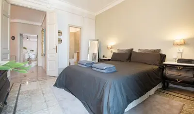 a bedroom with a bed with towels on it at You Stylish Boutique Apartments in Barcelona