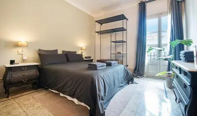 a bedroom with a bed and a desk and a window at You Stylish Boutique Apartments in Barcelona