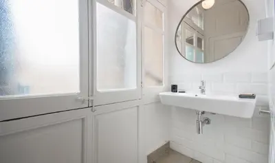 a white bathroom with a sink and a mirror at You Stylish Boutique Apartments in Barcelona