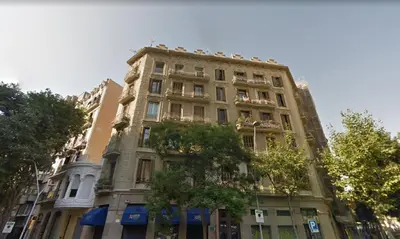 a tall building with a tree in front of it at You Stylish Boutique Apartments in Barcelona