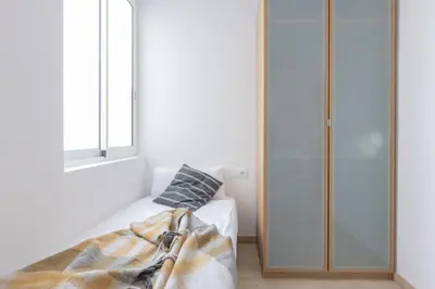 a bedroom with a bed and a window at Housalia Familia Rossellon in Barcelona