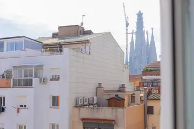 a view of a city with buildings and a cathedral at Housalia Familia Rossellon in Barcelona