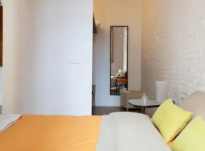 a bedroom with a bed and a table and a mirror at Borrell · Near ramblas in Barcelona