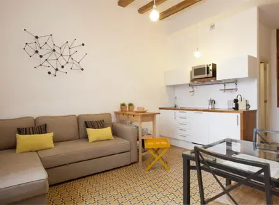 a living room with a couch and a kitchen at Borrell · Near ramblas in Barcelona