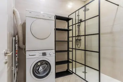 a laundry room with a washer and dryer at 2215 - AB Calabria Apartment in Barcelona