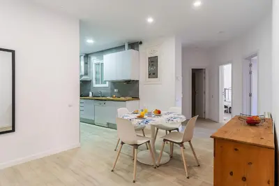 a kitchen and dining room with a table and chairs at 2215 - AB Calabria Apartment in Barcelona