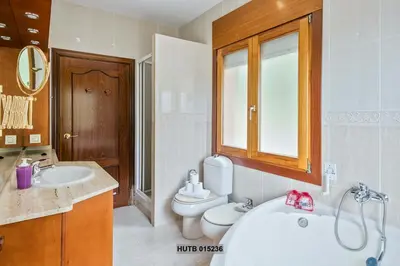 a bathroom with a toilet and a sink and a tub at Alcam Can Macia in Corbera de Llobregat