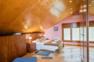 a bedroom with a bed and a wooden ceiling at Alcam Can Macia in Corbera de Llobregat