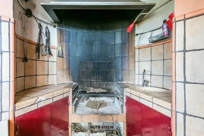 a kitchen with a sink and a bird cage at Alcam Can Macia in Corbera de Llobregat