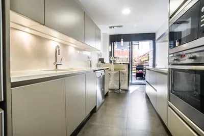 a kitchen with a sink and a stove at Luxury Apartment in Sitges City in Sitges