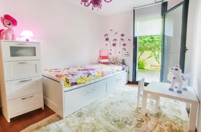 a childs bedroom with a bed and a tv at Luxury Apartment in Sitges City in Sitges