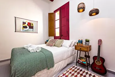 a bedroom with a bed and a guitar at Sweett - Raco in Barcelona