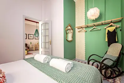 a green room with a bed and a chair at Sweett - Raco in Barcelona