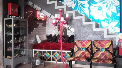 a living room with a red couch and stairs at Casa Miramiranda in Teià