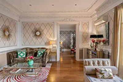 a living room with a couch and a table at HoHomes - Luxury Palacete in Barcelona
