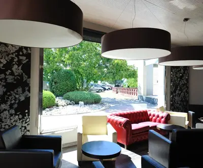 a living room with couches and chairs and a window at Hotel Els Noguers in Manresa