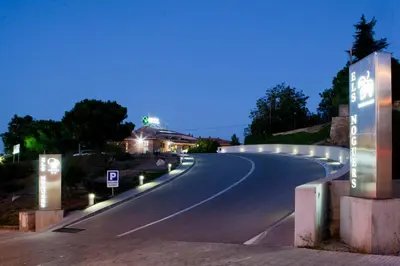 an empty road at night with lights on it at Hotel Els Noguers in Manresa