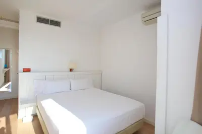 a white bedroom with a white bed in a room at Solvi Hotel - Adults Only in Vilanova i la Geltrú