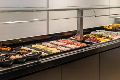 a buffet line with many different types of food at Naitly Barcelona Poblenou in Barcelona