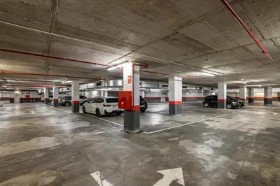 an empty parking garage with cars parked in it at Naitly Barcelona Poblenou in Barcelona