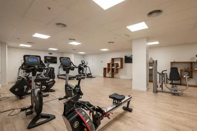 a gym with several treadmills and exercise bikes at Naitly Barcelona Poblenou in Barcelona
